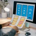 Empathy design: understanding users for meaningful experiences ux designer is reviewing paper prototypes of a mob nlr769m